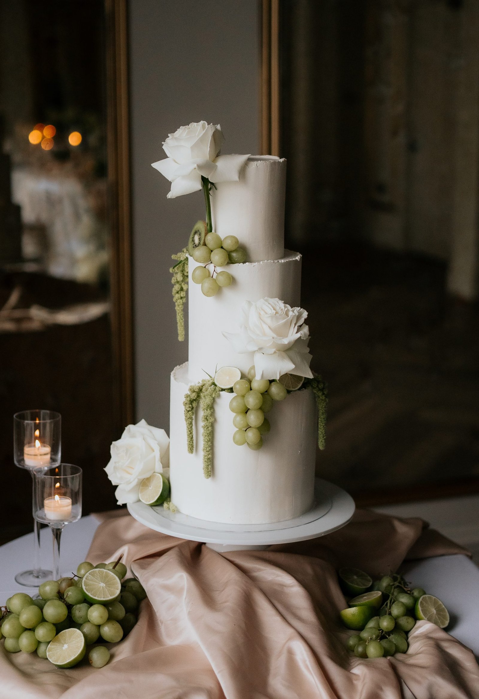 Elegant white wedding cake with white green fruit